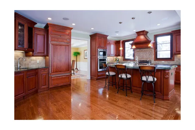 Traditional Kitchen — cherry wood cabinetry with stone backsplash and hardwood floors. Boston area.