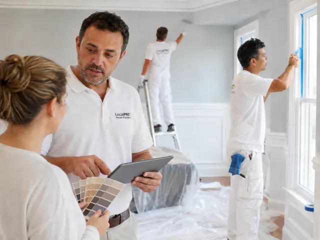 Painter reviewing color samples with a homeowner during an interior painting project