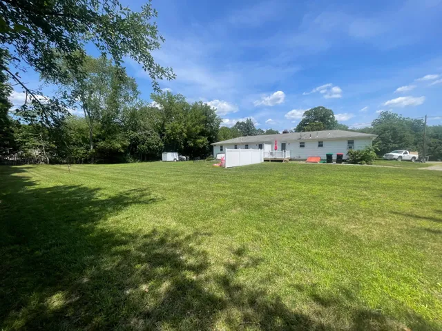 Freshly cut backyard behind a ranch home