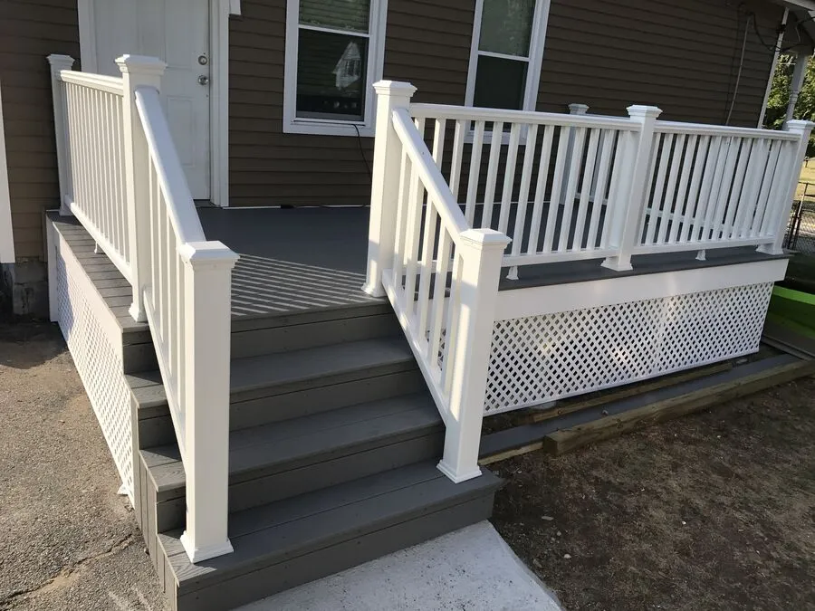 Completed composite deck with white railings and lattice skirt