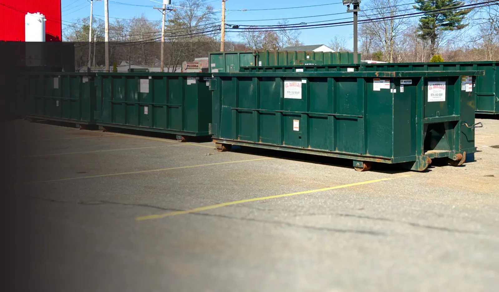 Row of G. Mello roll-off containers
