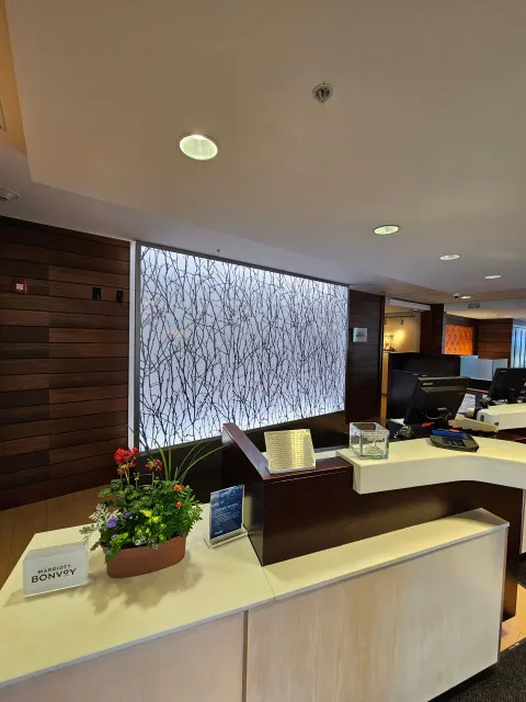 A reception desk in a hotel with flowers on it