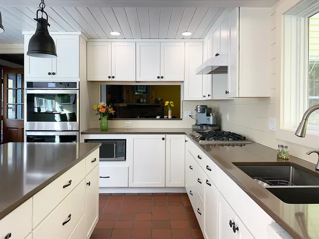 kitchen with wood ceiling and white cabinets