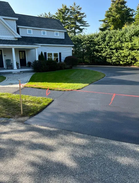 Sealcoated asphalt driveway edge in southern Maine