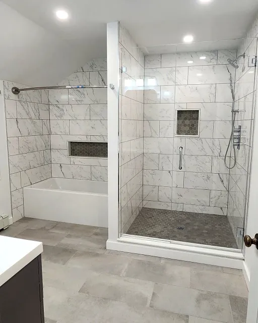 Finished Mid-City Stamford bathroom showing the walk-in shower and separate tub in marble-look porcelain