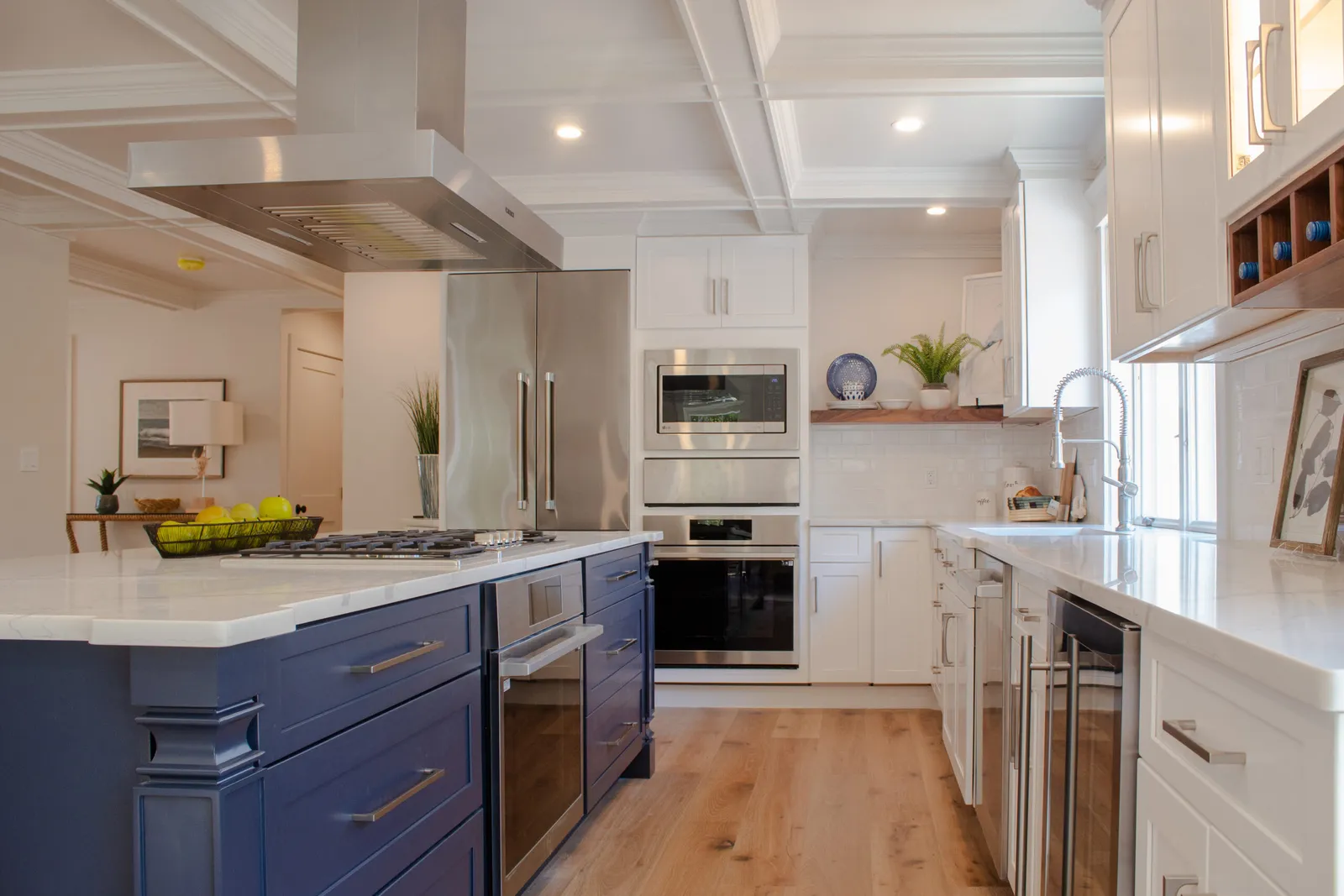 White and blue kitchen with wood floors