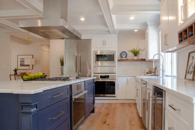 White and blue kitchen with wood floors