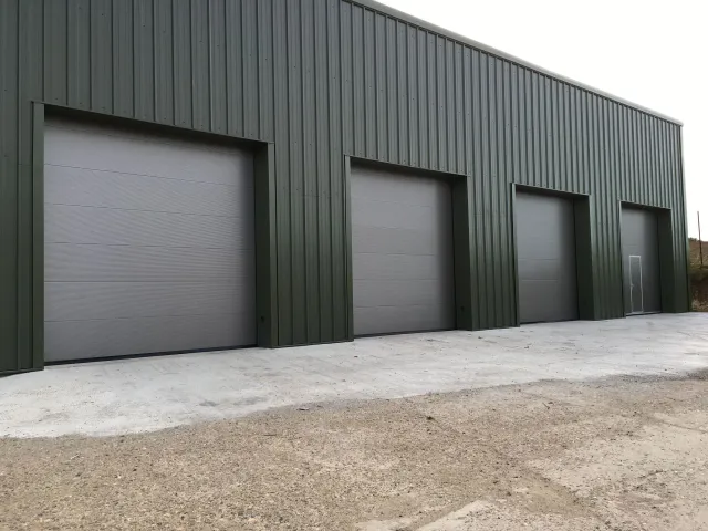 A row of garage doors on the side of a building.