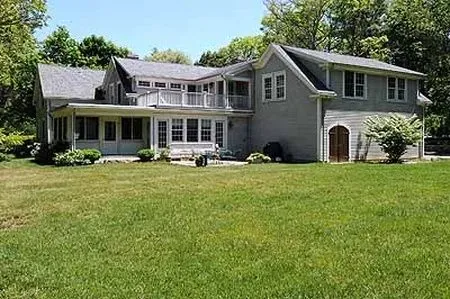 A large house with a large lawn in front of it.