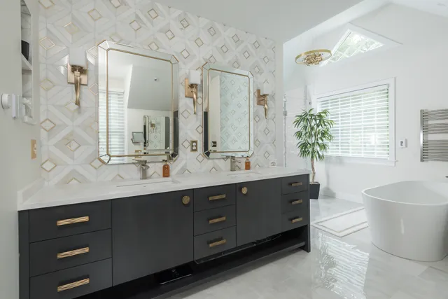Refined Norwell primary bathroom with cobblestone grey vanity and brass accents