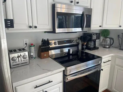 Sparkling clean modern kitchen with stainless steel appliances — maid service Sebago Lake region