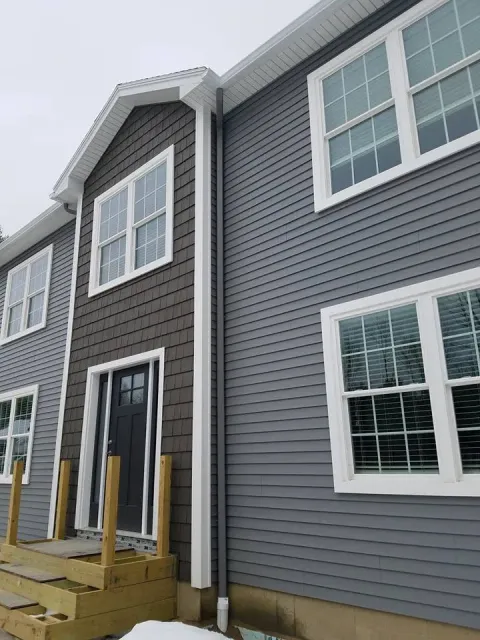 Gray home with seamless gutters