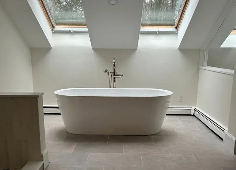 Bright remodeled bathroom with freestanding bathtub