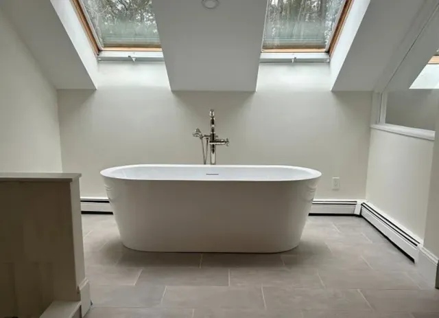 Bright remodeled bathroom with freestanding bathtub