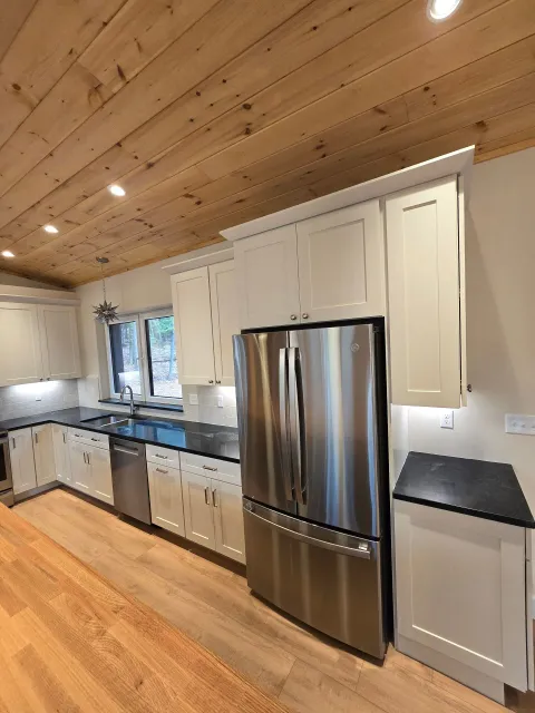A kitchen with stainless steel appliances and white cabinets