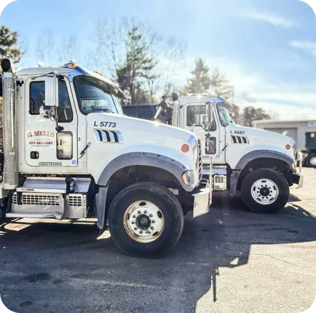 Two G. Mello Disposal trucks at the yard