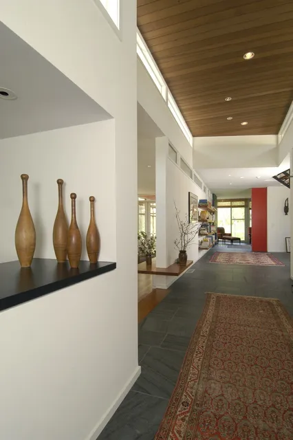 Gallery hallway with custom millwork and stone flooring