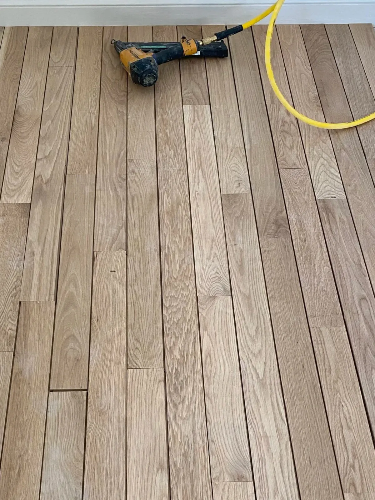 New oak flooring being nailed down