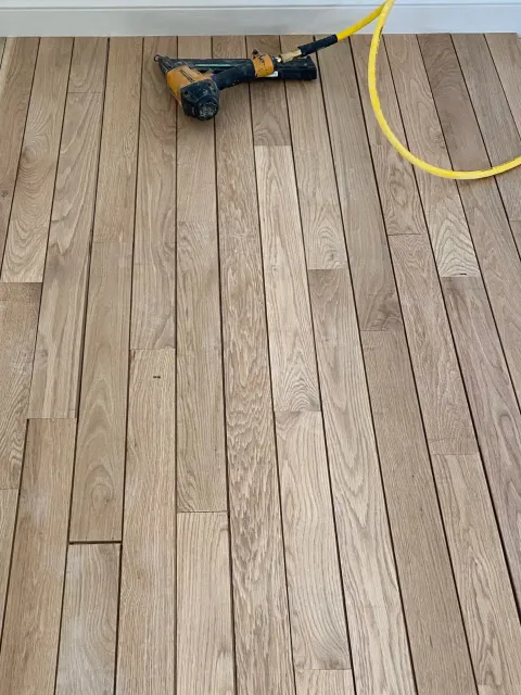 New oak flooring being nailed down