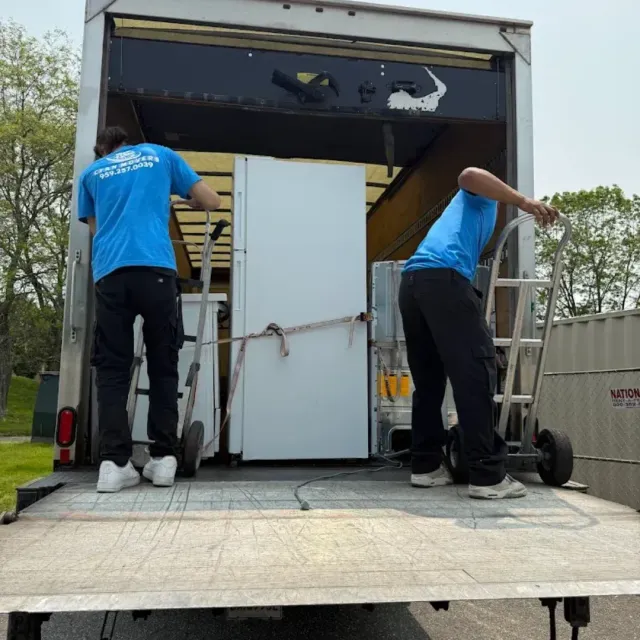 Professional movers loading furniture into a moving truck during a residential move in Connecticut