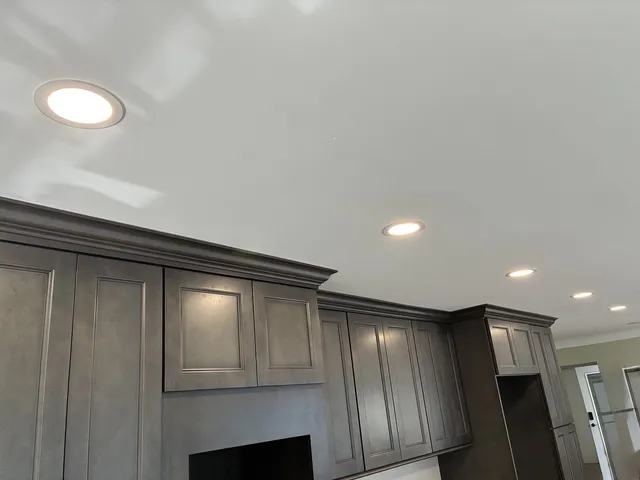 Finished kitchen with recessed lights at full brightness