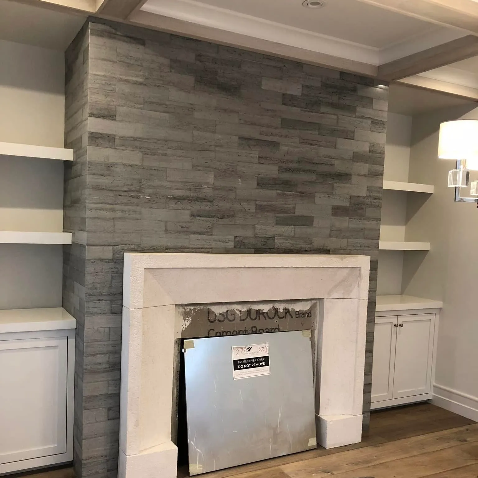 Stacked-stone fireplace surround with built-in shelving