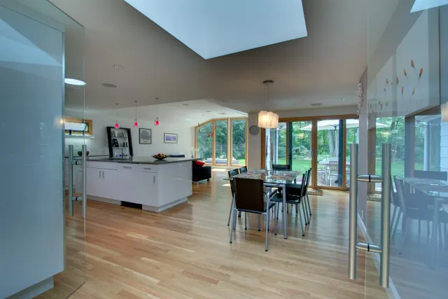bright open kitchen and dining area with skylights and hardwood floors by PEGASUS Design-to-Build in Arlington, MA-optimized