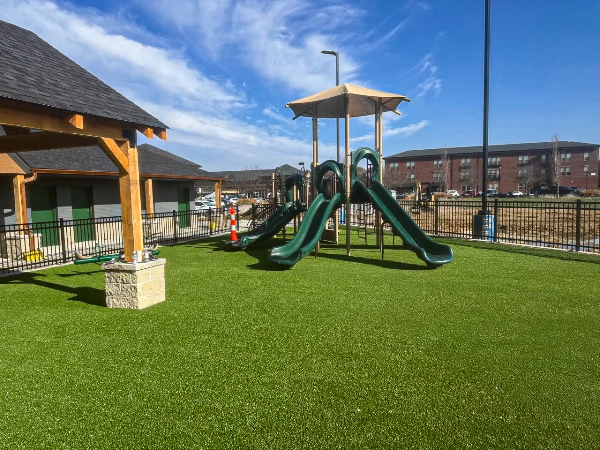 Completed Ameriplay, Ultra Real playground turf around the slide structure at the Lake St. Louis park project