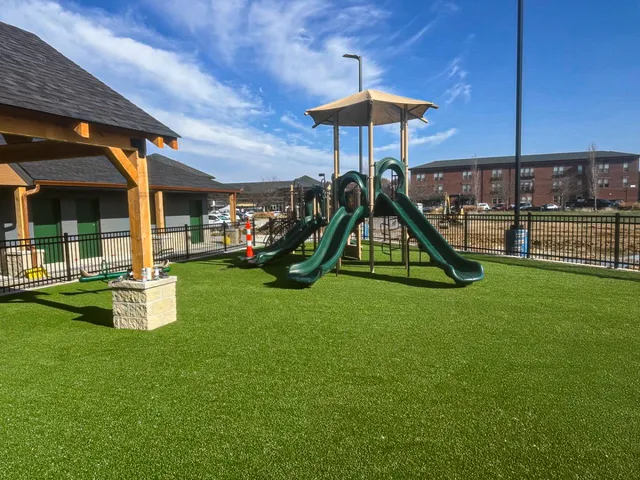 Completed Ameriplay, Ultra Real playground turf around the slide structure at the Lake St. Louis park project