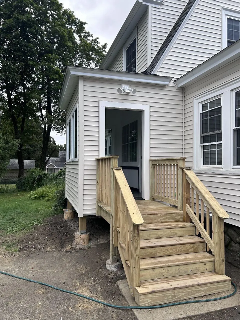 New pressure-treated stairs and railing at the addition door