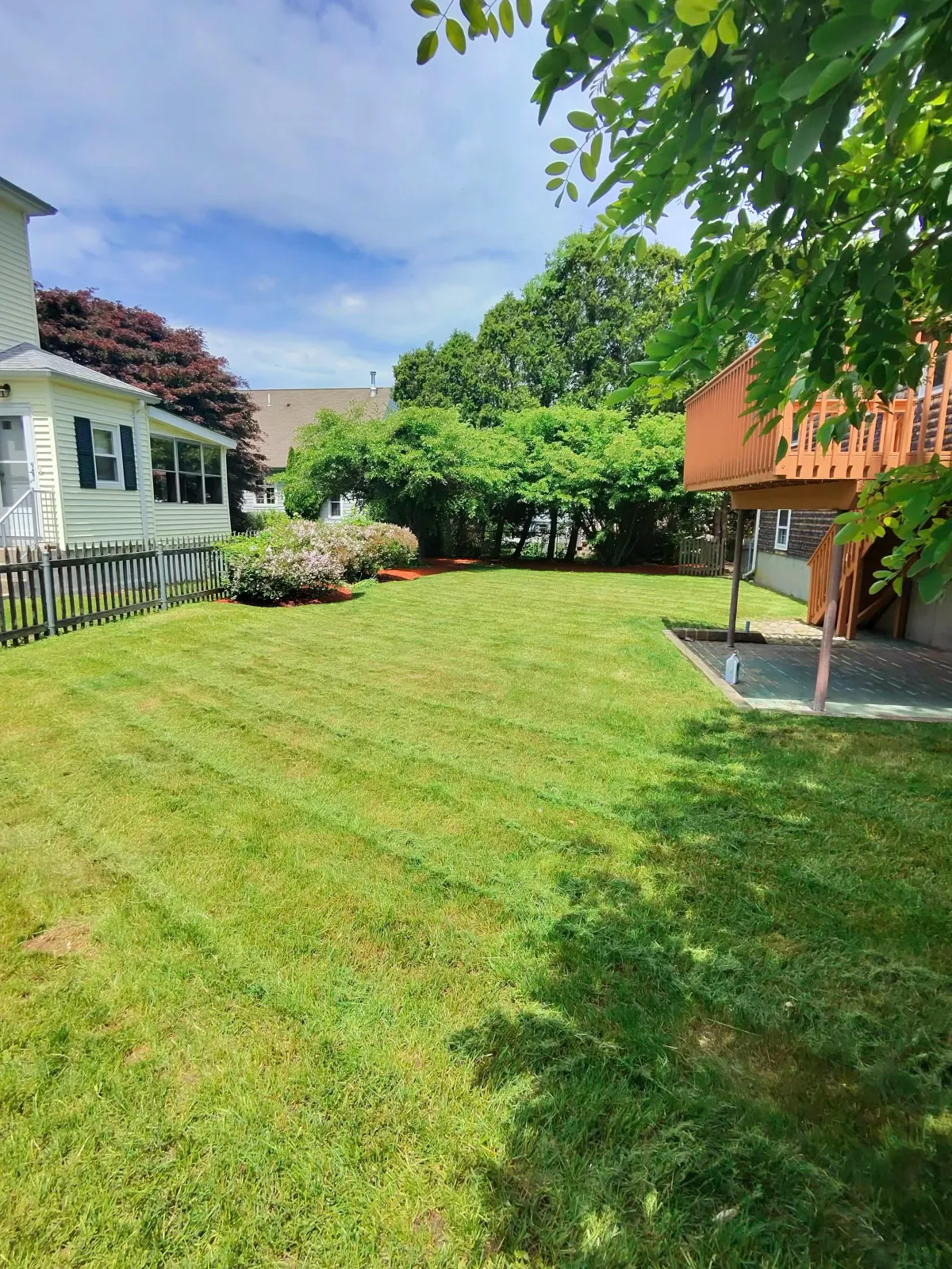 Professional landscaping services including lawn mowing, mulch installation, and edging by C&E Services in Rhode Island & Massachusetts