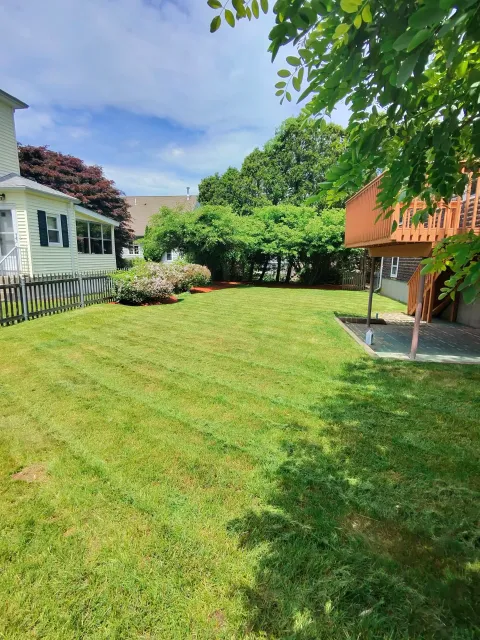 Professional landscaping services including lawn mowing, mulch installation, and edging by C&E Services in Rhode Island & Massachusetts