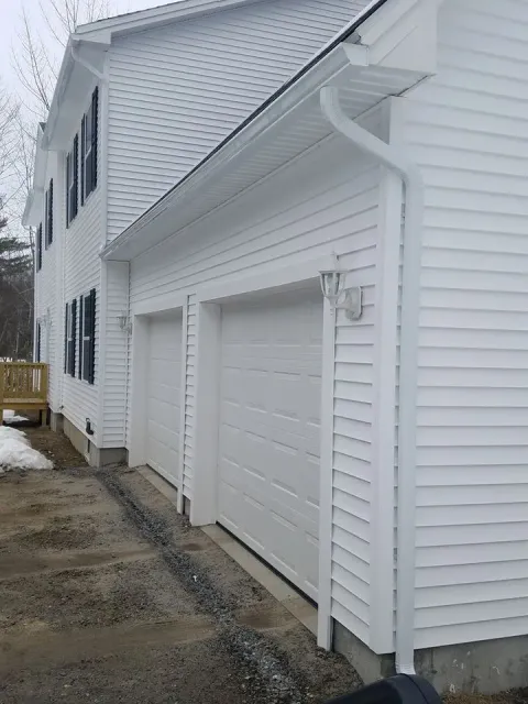 Seamless gutters installed above garage