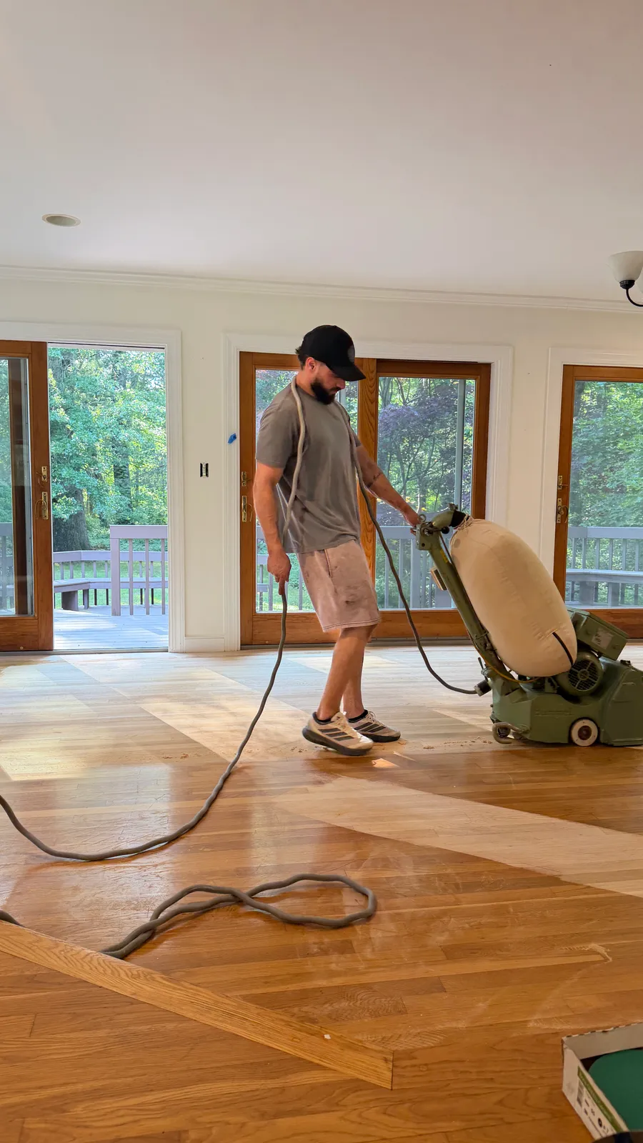 Hardwood floor sanding in progress with a professional floor sander