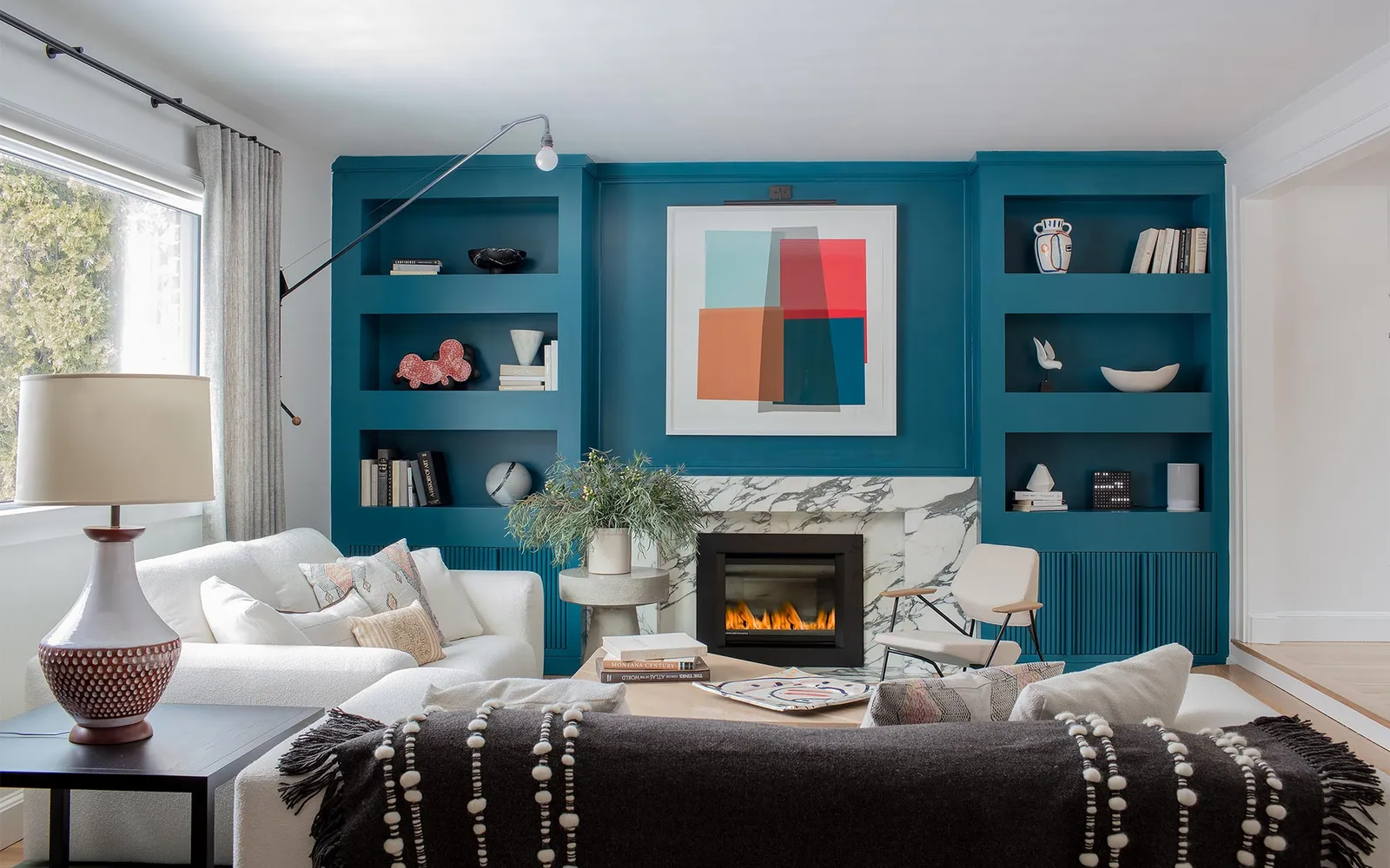 A living room filled with furniture and a fire place