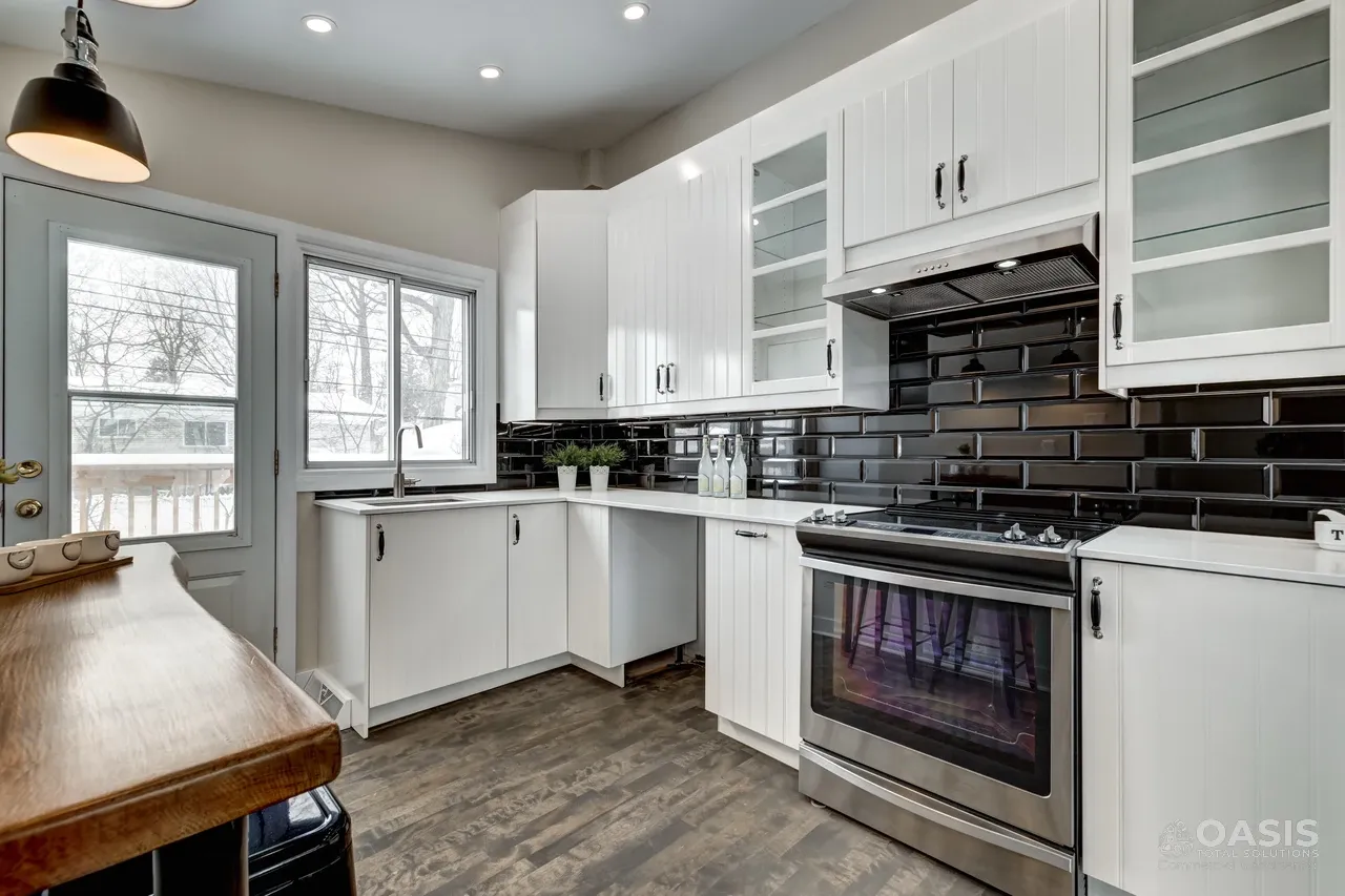 Completed white kitchen with glossy black subway tile backsplash