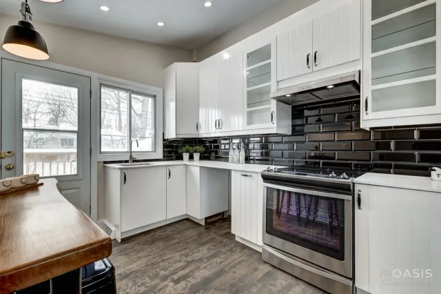 Completed white kitchen with glossy black subway tile backsplash