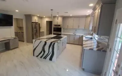 A kitchen with a large island and a zebra print counter top.