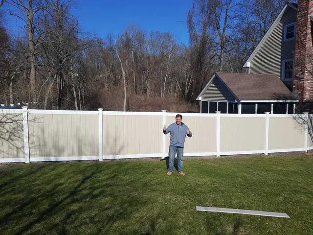 Happy customer with vinyl fence installation