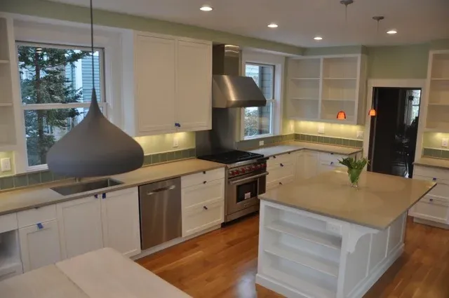 Kitchen with large island, hood and custom built-ins