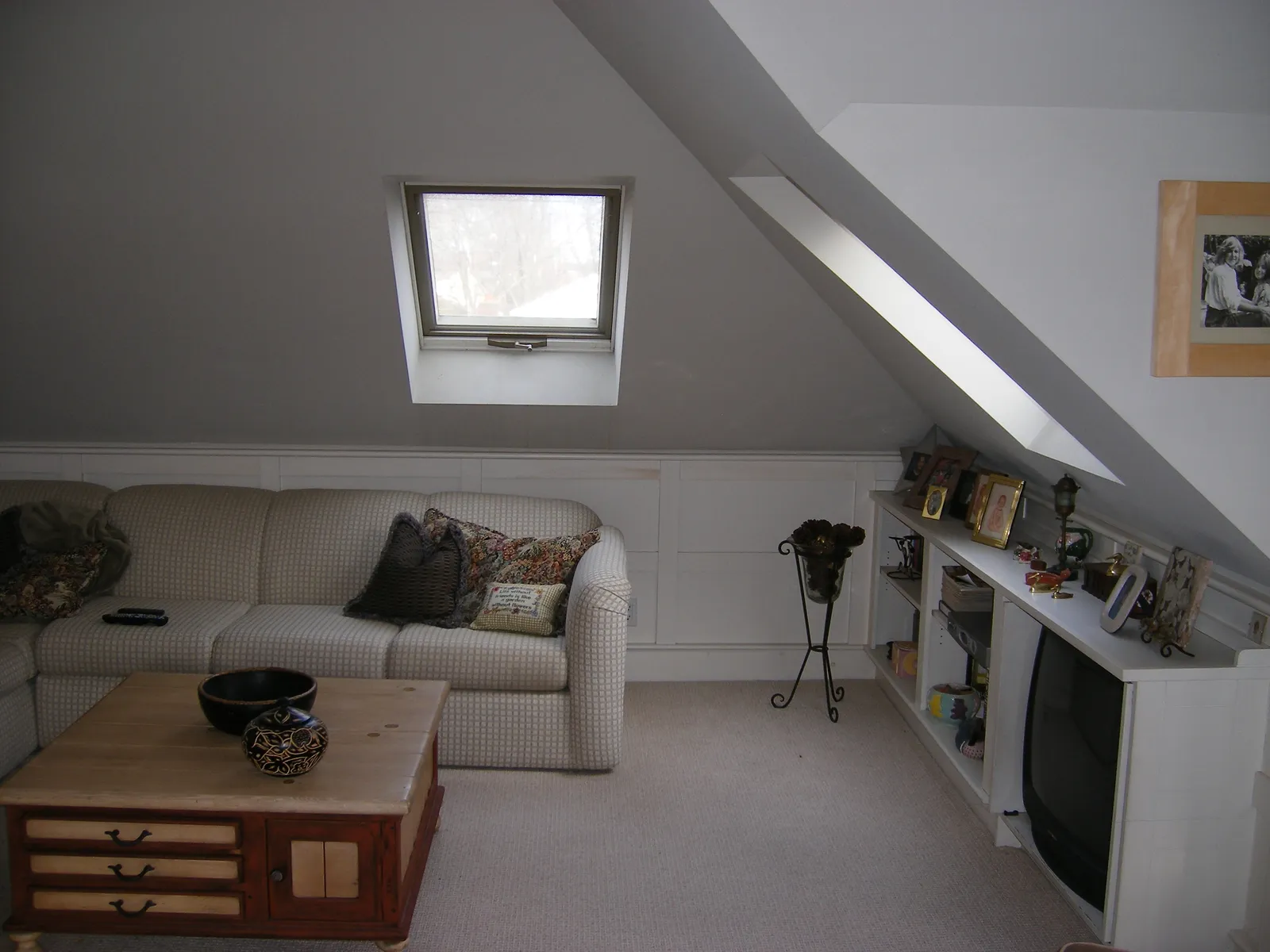 Finished attic/loft living space with skylight and built-in shelving
