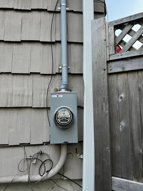Electric Meter Box and Wiring Installation on the Exterior of a House
