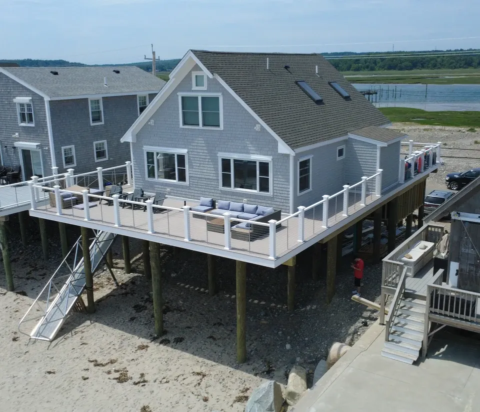 Elevated beach house deck and stairs in Humarock, MA by Luxus Construction