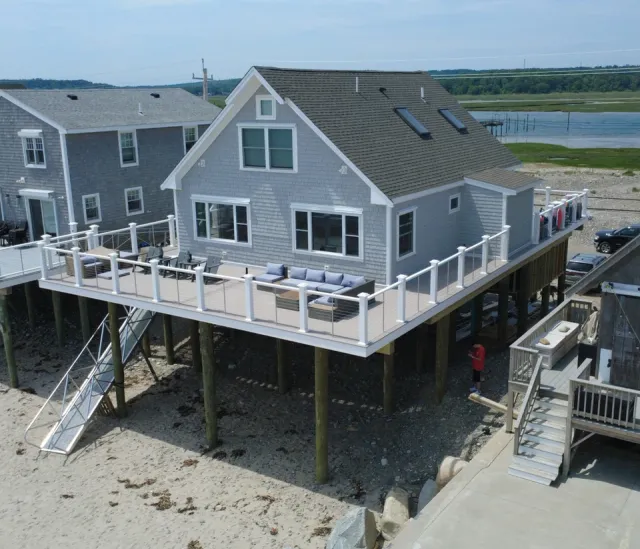 Elevated beach house deck and stairs in Humarock, MA by Luxus Construction