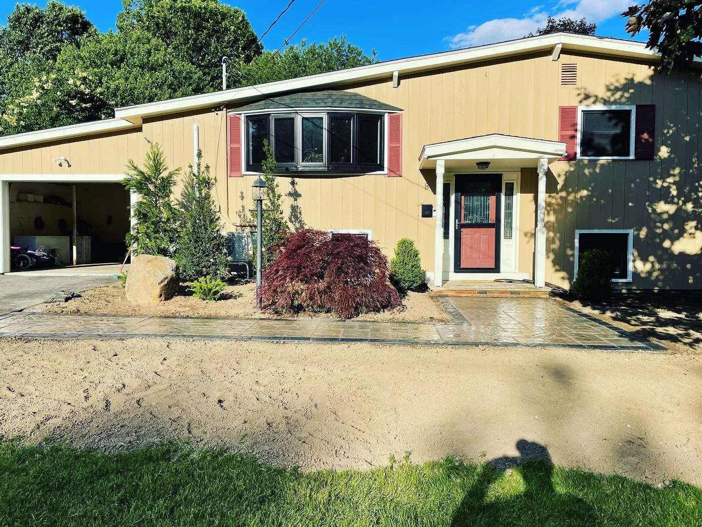 What a transformation, some smaller plants to save a little green that will grow along with this family into a the perfect front entranceway! Great job my our design team creating a plan to replace the front beds and walkway that works with our customers budget and an even better execution job by our crew!