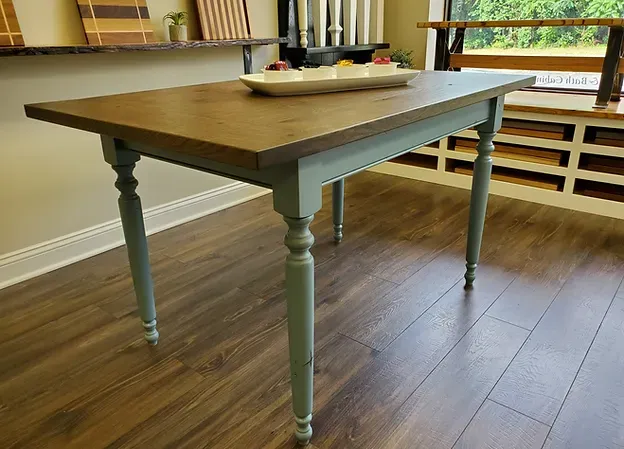 Custom wood-top dining table with painted blue-gray turned legs.