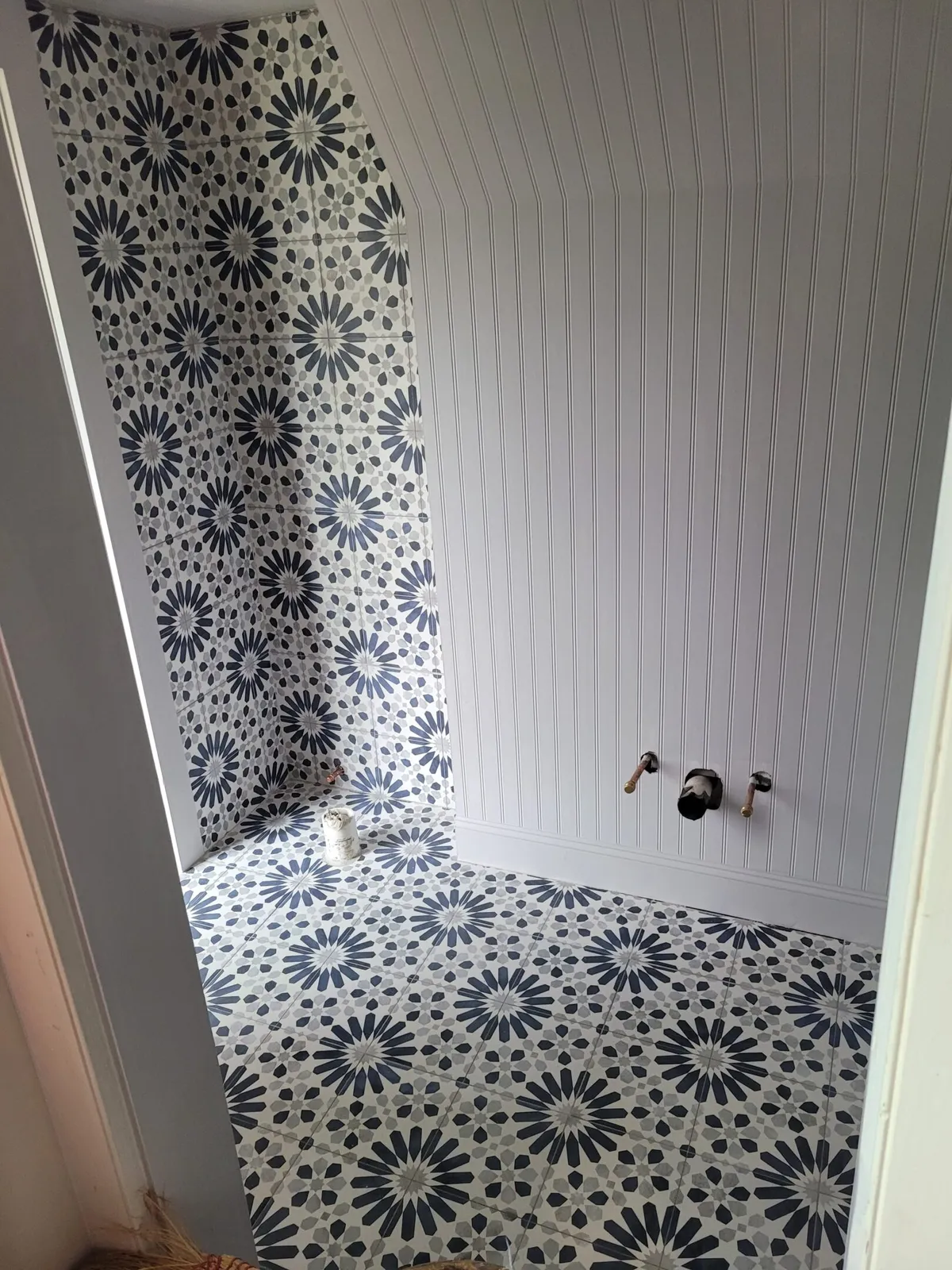 A bathroom with a black and white tile floor.