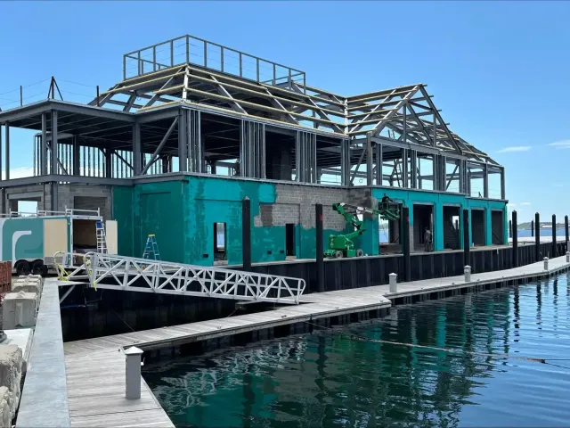 Waterfront commercial building with teal exterior waterproofing applied to the block walls