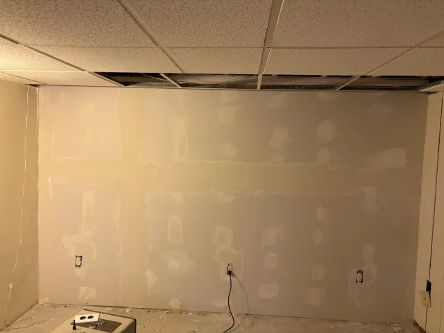 New basement drywall installed with seams and fasteners filled for finishing