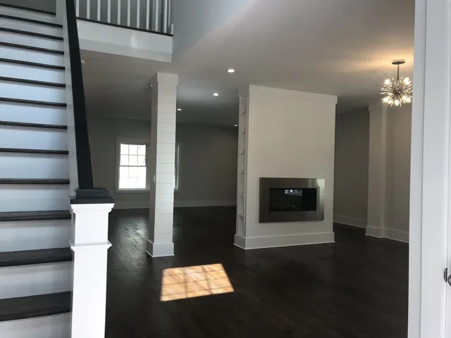 Living room with a two sided fireplace and shiplap column